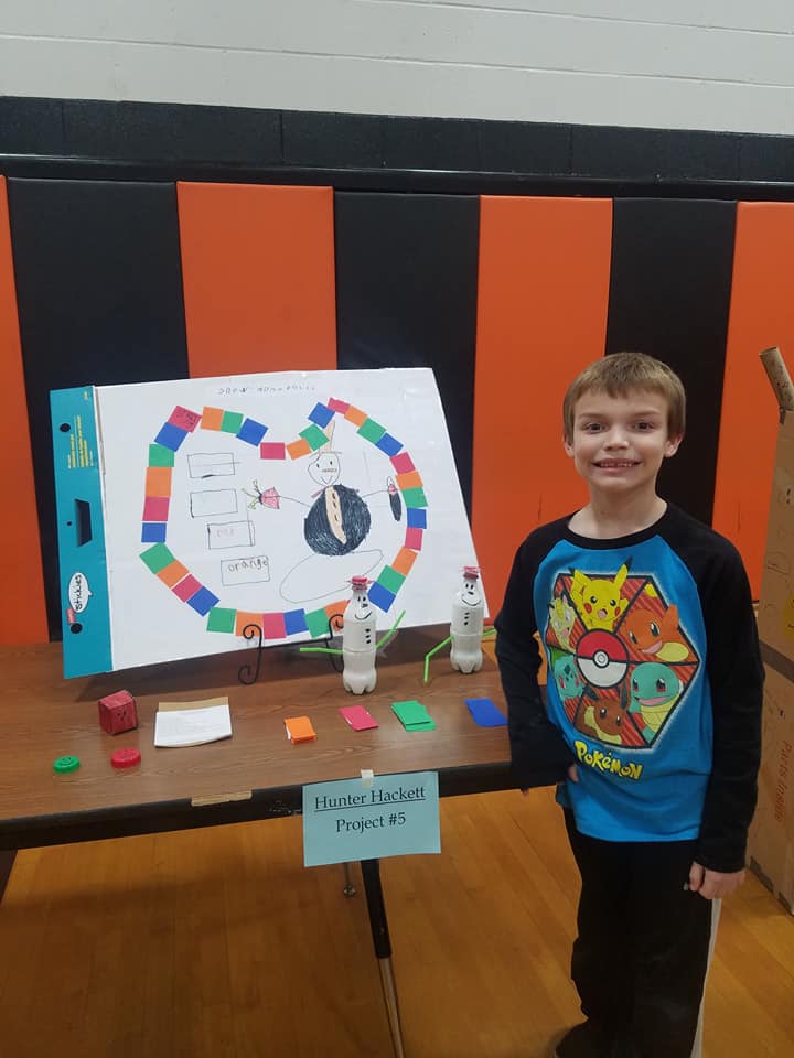 boy standing in front of a display